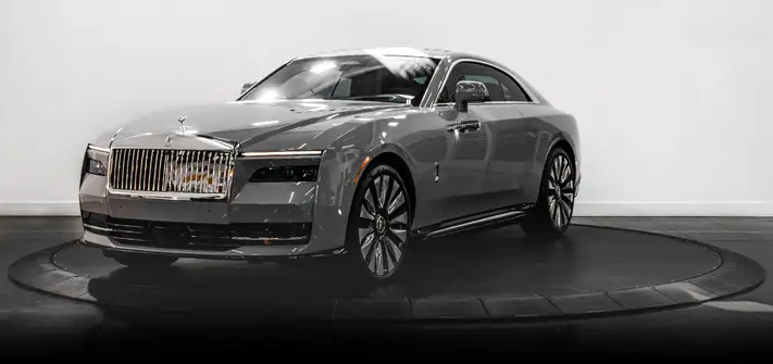 Grey on blue Rolls Royce Spectre rental profile view - Orlando exotic car rental