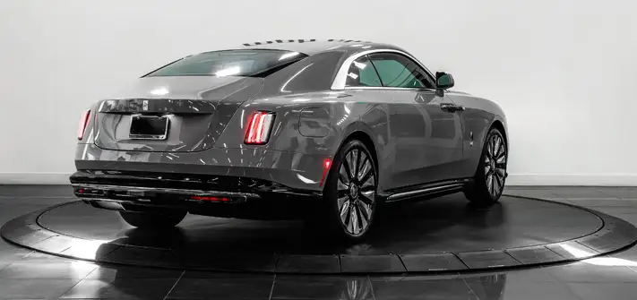 Grey on blue Rolls Royce Spectre rental rear view - Orlando exotic car rental