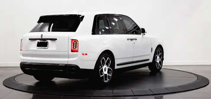 White on blue Rolls Royce Cullinan Black Badge rental rear view - Orlando exotic car rental